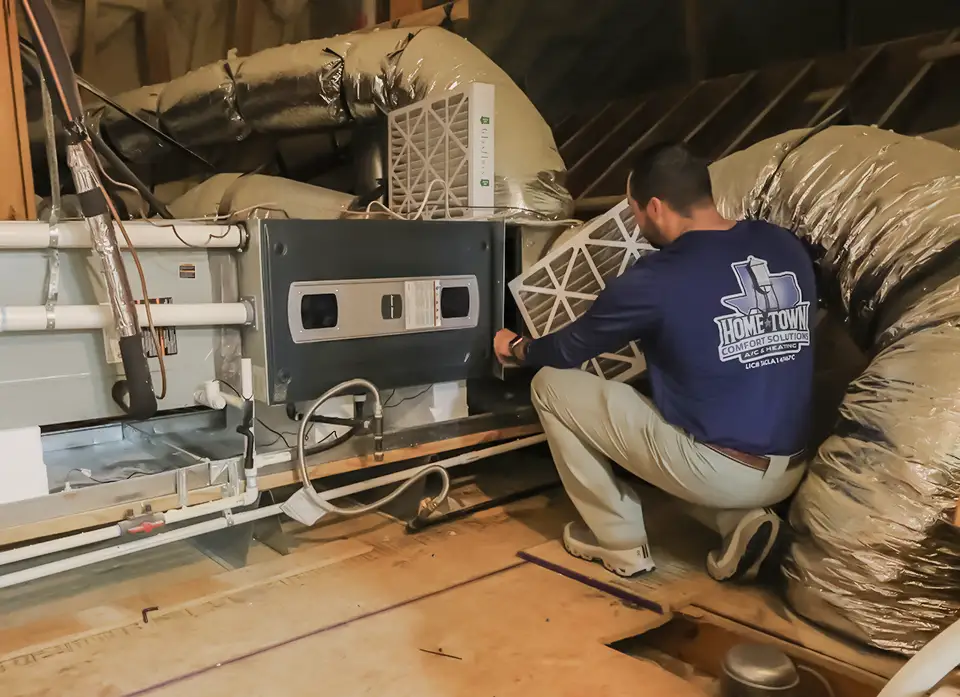 Home Town Comfort Solutions performs a repair on an attic unit